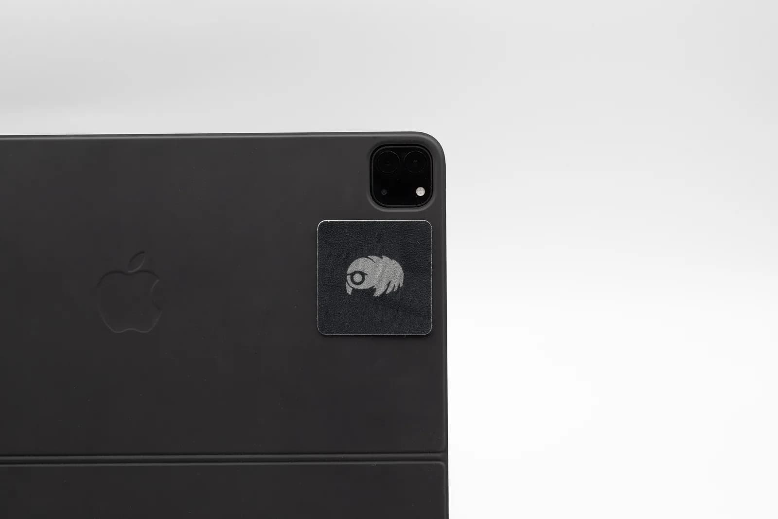 A reusable screen cleaner attached to the back of a tablet